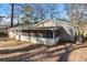 Rear view of the house showing the screened porch and yard at 2307 Cresta Dr, Decatur, GA 30032