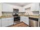 Modern kitchen featuring granite countertops and white cabinets at 2307 Cresta Dr, Decatur, GA 30032