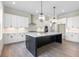 Modern kitchen with white shaker cabinets, a large island, and pendant lighting at 3325 Hillshire Dr, Cumming, GA 30028