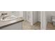 Bathroom with double sinks, garden tub, and separate shower at 120 Bonito Trl, Covington, GA 30016