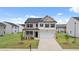 Two-story house with a neutral color scheme and a two-car garage at 120 Bonito Trl, Covington, GA 30016