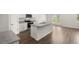 Modern kitchen with island, stainless steel appliances, and hardwood floors at 120 Bonito Trl, Covington, GA 30016