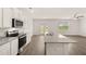 Modern kitchen with island, stainless steel appliances, and hardwood floors at 120 Bonito Trl, Covington, GA 30016
