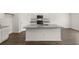 Modern kitchen with island, granite countertops, and hardwood floors at 120 Bonito Trl, Covington, GA 30016