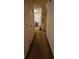 Long hallway with white walls and carpeted floors at 1771 Fielding Way, Hampton, GA 30228