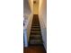 Staircase with carpeted steps and wooden railing at 1771 Fielding Way, Hampton, GA 30228