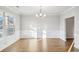 Light-filled dining room with hardwood floors and a chandelier at 2448 Bear Mountain St, Lithonia, GA 30058