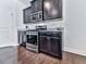 Modern kitchen with stainless steel appliances and dark wood cabinets at 5512 Cascade Run, South Fulton, GA 30336