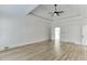 Spacious main bedroom with hardwood floors, tray ceiling, and ceiling fan at 215 Southern Hill Dr, Johns Creek, GA 30097