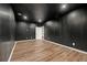 Finished basement room with dark walls and luxury vinyl flooring at 7250 Weber St, Atlanta, GA 30349