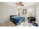 Bright bedroom with a queen bed, ceiling fan, and wooded views at 7250 Weber St, Atlanta, GA 30349