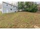 House backyard with sloping terrain and mature trees at 3597 Fairlane Nw Dr, Atlanta, GA 30331