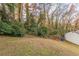 Sloping backyard with lush greenery and trees at 3597 Fairlane Nw Dr, Atlanta, GA 30331