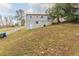 House backyard with sloping terrain and mature trees at 3597 Fairlane Nw Dr, Atlanta, GA 30331