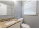 Clean bathroom with granite countertop, white vanity, and tiled shower at 3597 Fairlane Nw Dr, Atlanta, GA 30331