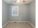 Simple bedroom with gray walls, carpet flooring, and a window with blinds at 3597 Fairlane Nw Dr, Atlanta, GA 30331