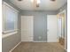 Bright bedroom featuring gray walls, carpet, and built-in closet at 3597 Fairlane Nw Dr, Atlanta, GA 30331