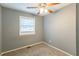 Simple bedroom with gray walls, carpet flooring, and a window with blinds at 3597 Fairlane Nw Dr, Atlanta, GA 30331