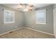 Spacious bedroom with neutral walls, carpet, ceiling fan, and window blinds at 3597 Fairlane Nw Dr, Atlanta, GA 30331