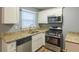Galley kitchen, granite countertops, stainless steel appliances at 3597 Fairlane Nw Dr, Atlanta, GA 30331