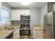 Modern kitchen with stainless steel appliances and granite counters at 3597 Fairlane Nw Dr, Atlanta, GA 30331