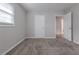 Spacious bedroom with neutral walls, carpet, and access to bathroom and hallway at 4557 Greenleaf Sw Cir, Atlanta, GA 30331
