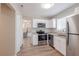 Modern kitchen with white cabinets and stainless steel appliances at 4557 Greenleaf Sw Cir, Atlanta, GA 30331