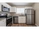 Modern kitchen with white cabinets and stainless steel appliances at 4557 Greenleaf Sw Cir, Atlanta, GA 30331
