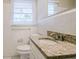 Clean bathroom with granite countertop and white tile at 2168 Polar Rock Sw Pl, Atlanta, GA 30315