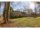 Large backyard with deck, playset, and wooded area at 1193 Colony Dr, Marietta, GA 30068