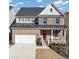 Two-story brick home with a white front door and a metal roof at 4349 Northmark Ln, Buford, GA 30518