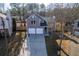 Aerial view of a gray house with a two-car garage and yard at 4187 Mistymorn Way, Powder Springs, GA 30127