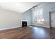 Bright living room with hardwood floors, fireplace, and large window at 4187 Mistymorn Way, Powder Springs, GA 30127