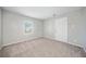 Well-lit bedroom with neutral carpeting and a large closet at 1102 Forest East Dr, Stone Mountain, GA 30088