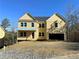 Two-story yellow house with a large garage and a covered porch at 171 Silvercrest Dr, Acworth, GA 30101