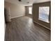 Spacious bedroom with grey wood-look floors and large windows at 2429 Birkhall Way, Lawrenceville, GA 30043