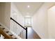 Bright hallway with hardwood floors and staircase at 6490 Mockingbird Rd, Cumming, GA 30028