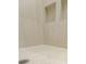 Custom shower with built-in shelves and neutral tile at 6490 Mockingbird Rd, Cumming, GA 30028