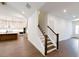 Elegant staircase with dark wood accents and white railing at 6490 Mockingbird Rd, Cumming, GA 30028