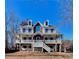 Two-story house with stone accents, wrap-around porch, and mature trees at 31 River Walk Pkwy, Euharlee, GA 30145