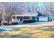 Ranch home with green siding, red shutters, and a white porch at 5923 Liberty Rd, Winston, GA 30187