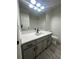 Bathroom with gray vanity, white countertop, and wood-look tile floor at 360 Chestnut Dr, Covington, GA 30016