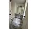 Bathroom with gray vanity and wood-look tile floor at 360 Chestnut Dr, Covington, GA 30016