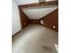 Small attic bedroom with brown walls and carpet at 360 Chestnut Dr, Covington, GA 30016