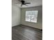 Bright bedroom with ceiling fan and window overlooking neighborhood at 360 Chestnut Dr, Covington, GA 30016