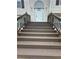 Brown stained wooden stairs leading to the front door at 360 Chestnut Dr, Covington, GA 30016