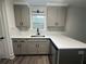 L-shaped kitchen with white quartz countertops and gray cabinets at 360 Chestnut Dr, Covington, GA 30016