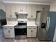 Modern kitchen with stainless steel appliances and white quartz countertops at 360 Chestnut Dr, Covington, GA 30016