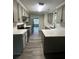 Renovated kitchen features modern appliances, quartz countertops, and gray cabinets at 360 Chestnut Dr, Covington, GA 30016