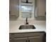 Modern kitchen sink with black faucet and white quartz countertop at 360 Chestnut Dr, Covington, GA 30016